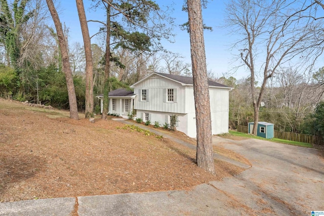 view of side of property featuring a shed