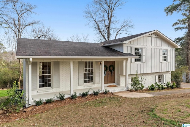 tri-level home with a front yard and a porch