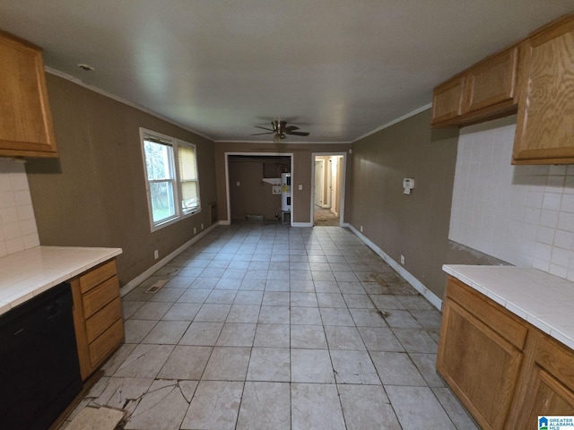 kitchen with crown molding, ceiling fan, black dishwasher, and tasteful backsplash