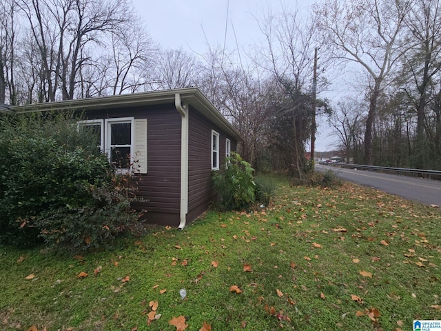 view of side of home featuring a lawn