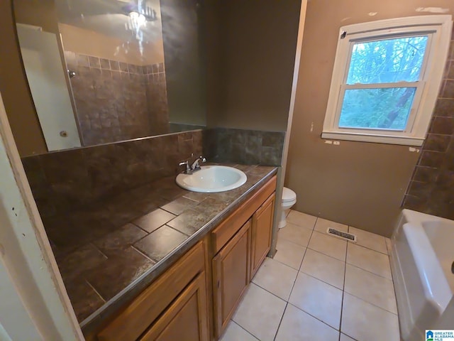 bathroom featuring tile patterned flooring, vanity, and toilet