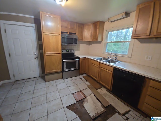 kitchen with appliances with stainless steel finishes, decorative backsplash, sink, and light tile patterned floors