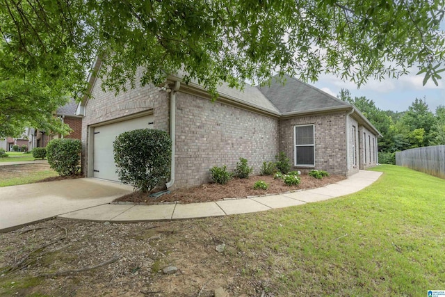 view of property exterior featuring a garage and a lawn