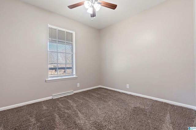 carpeted spare room featuring ceiling fan