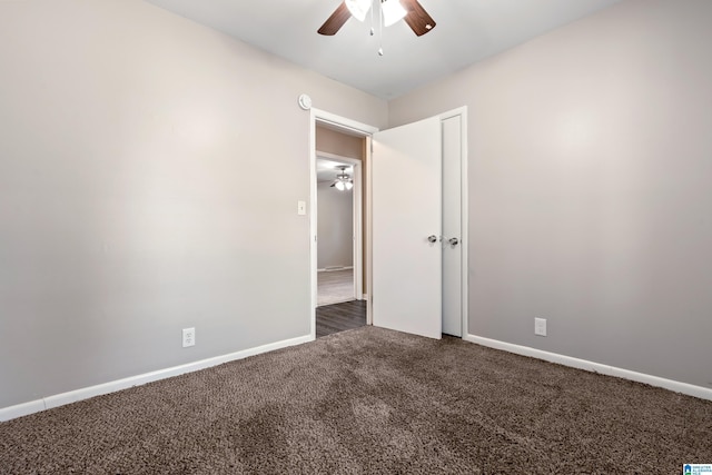 unfurnished bedroom featuring dark carpet and ceiling fan