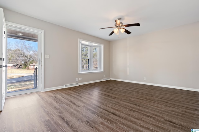 spare room featuring ceiling fan and dark wood-type flooring