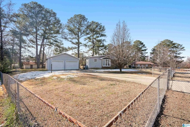 ranch-style home with a garage and an outbuilding