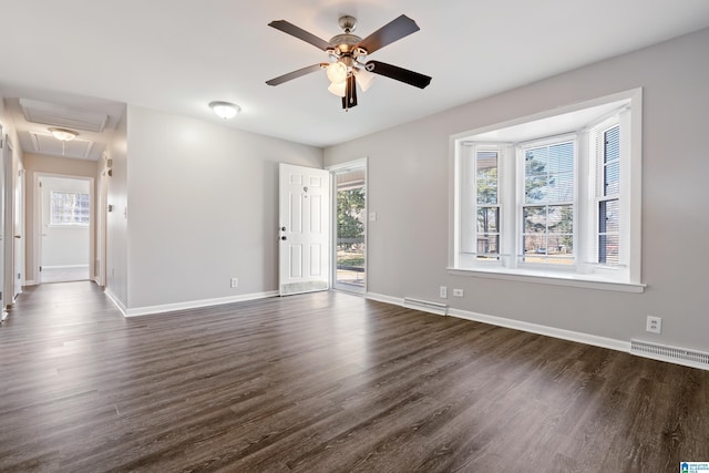 empty room with ceiling fan and dark wood-type flooring