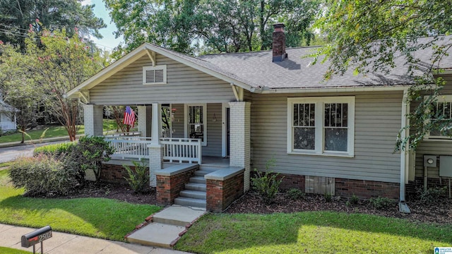 view of front of house featuring a front yard and covered porch