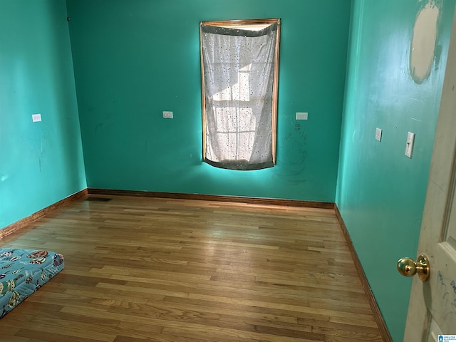 empty room with light hardwood / wood-style flooring