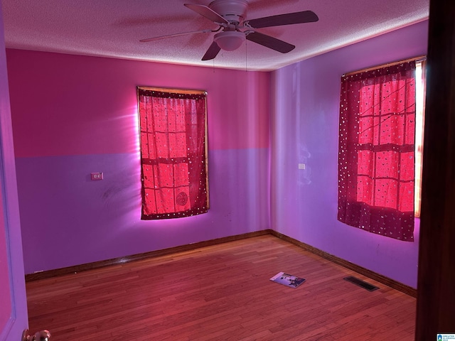 spare room featuring ceiling fan and wood-type flooring