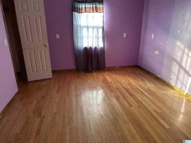 spare room with light hardwood / wood-style flooring