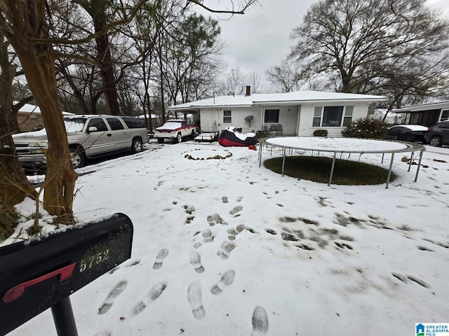 view of snow covered back of property