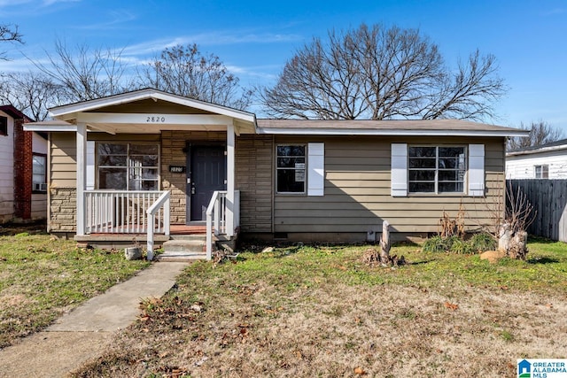 view of front of property with a front yard and covered porch