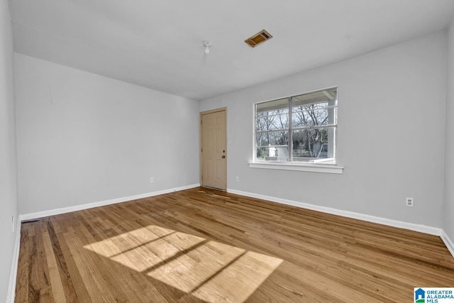 empty room with hardwood / wood-style flooring