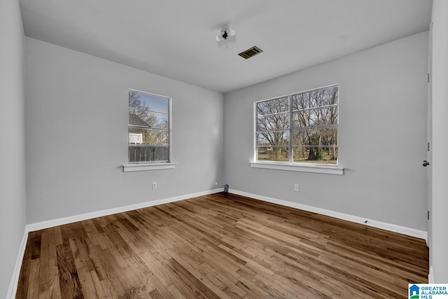 unfurnished room featuring hardwood / wood-style flooring