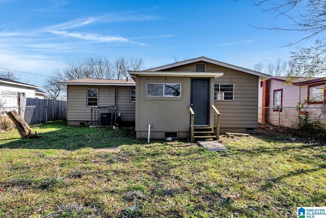 back of property featuring a yard