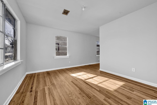 spare room with hardwood / wood-style floors