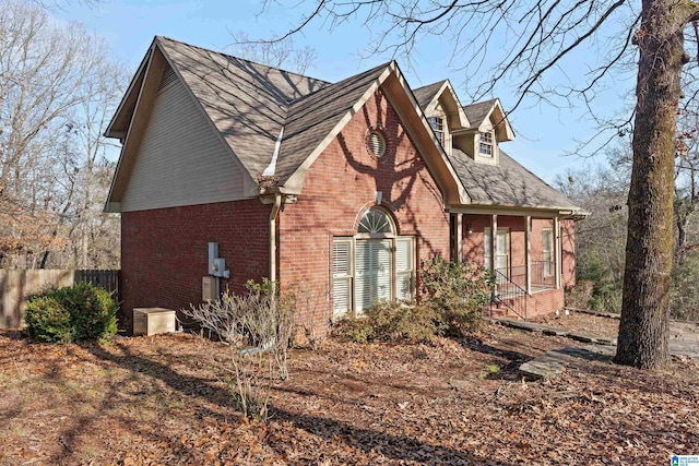 view of side of property featuring a sunroom