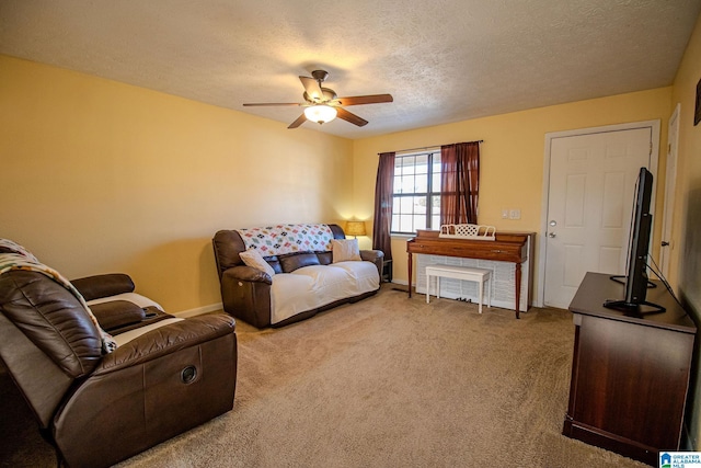 carpeted living room featuring a textured ceiling and ceiling fan