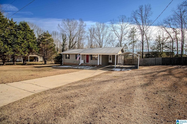 ranch-style house with a front yard and a carport