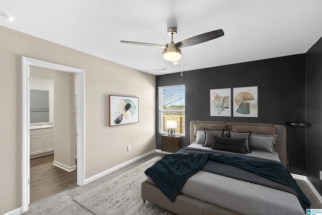 carpeted bedroom featuring ceiling fan and ensuite bathroom