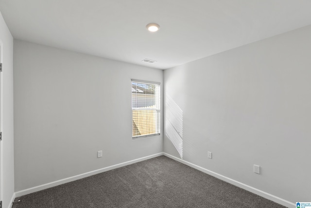 empty room featuring dark carpet