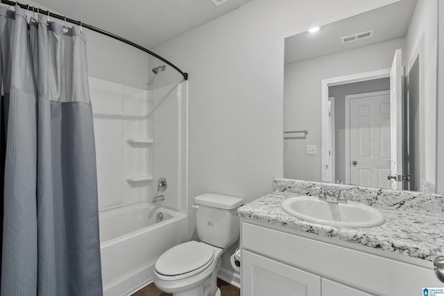 full bathroom featuring toilet, shower / tub combo with curtain, and vanity