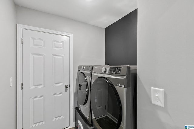 clothes washing area featuring washer and dryer