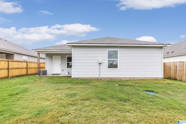 rear view of house with a yard