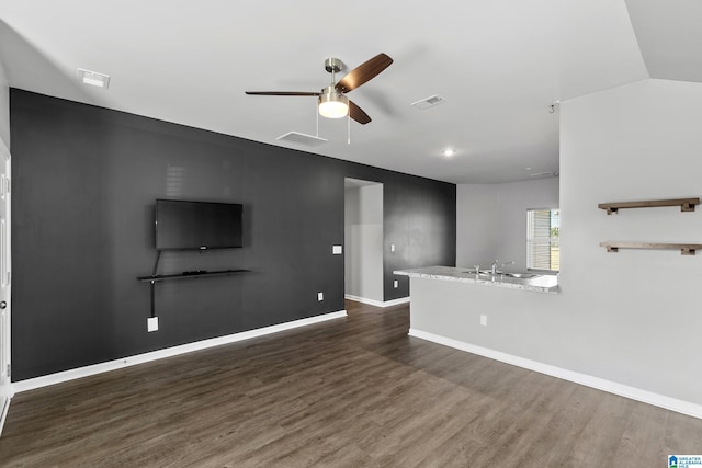 unfurnished living room featuring sink, ceiling fan, and dark hardwood / wood-style floors