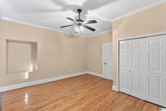 unfurnished bedroom featuring ceiling fan, light wood-type flooring, ornamental molding, and a closet