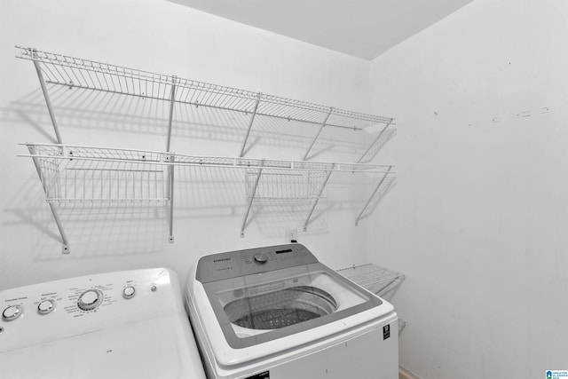 clothes washing area featuring separate washer and dryer