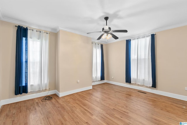 empty room with ornamental molding, ceiling fan, and light wood-type flooring