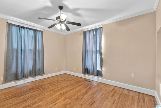 empty room featuring ceiling fan, light hardwood / wood-style flooring, and crown molding