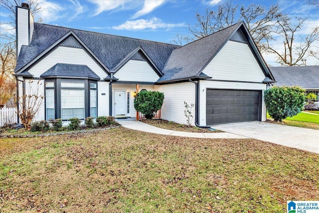 view of front of home with a front yard and a garage