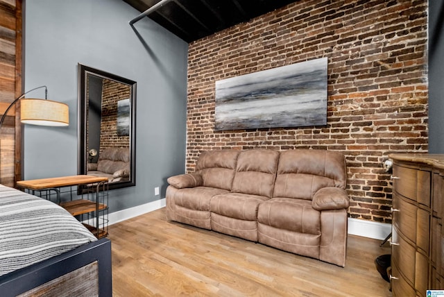 interior space featuring brick wall and hardwood / wood-style floors