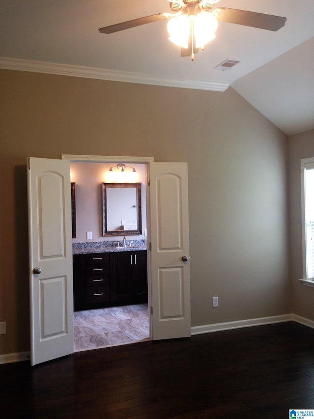 interior space featuring ceiling fan, crown molding, and dark hardwood / wood-style floors