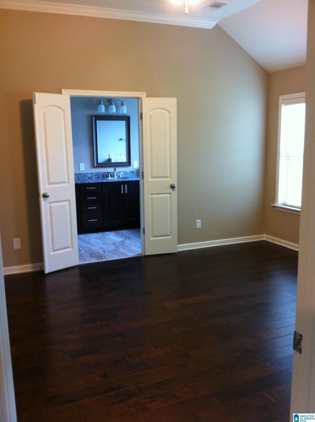 unfurnished living room featuring lofted ceiling, ornamental molding, dark hardwood / wood-style flooring, and sink