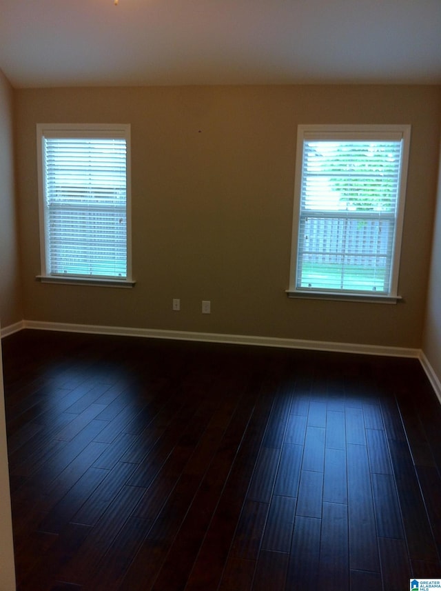 unfurnished room featuring dark hardwood / wood-style flooring