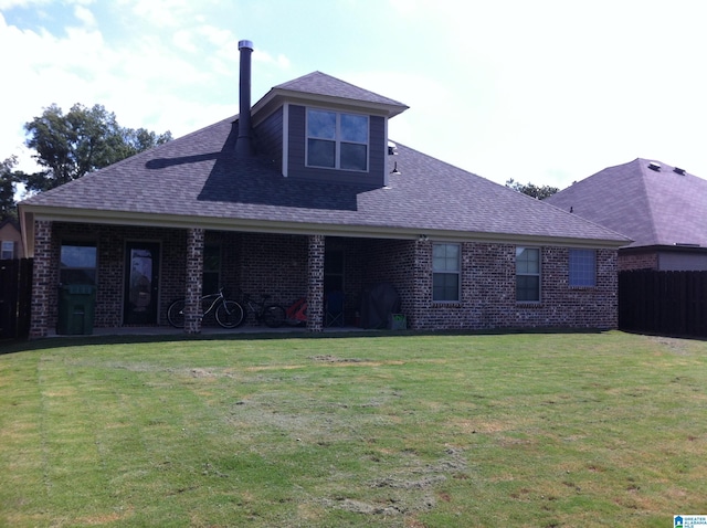 back of house with a lawn