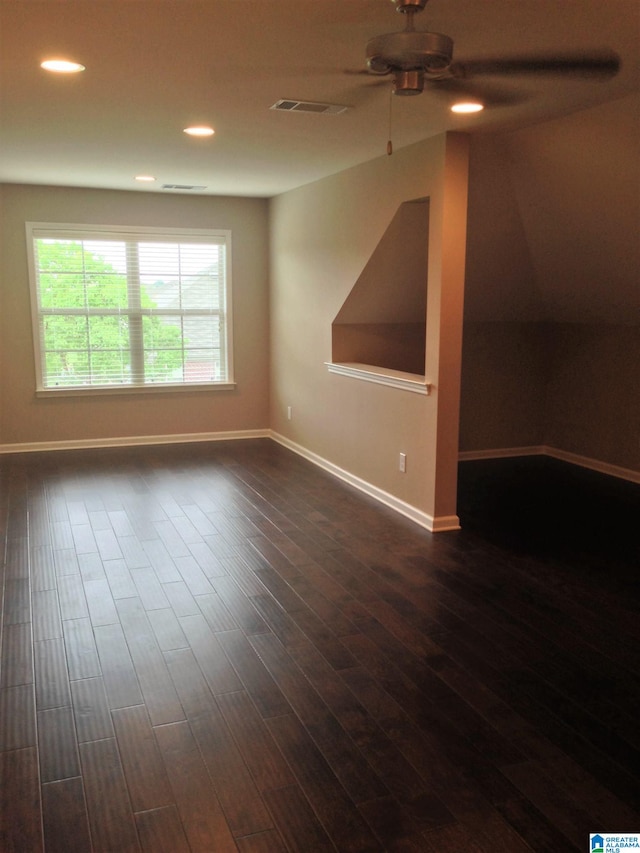 bonus room with ceiling fan and dark hardwood / wood-style flooring