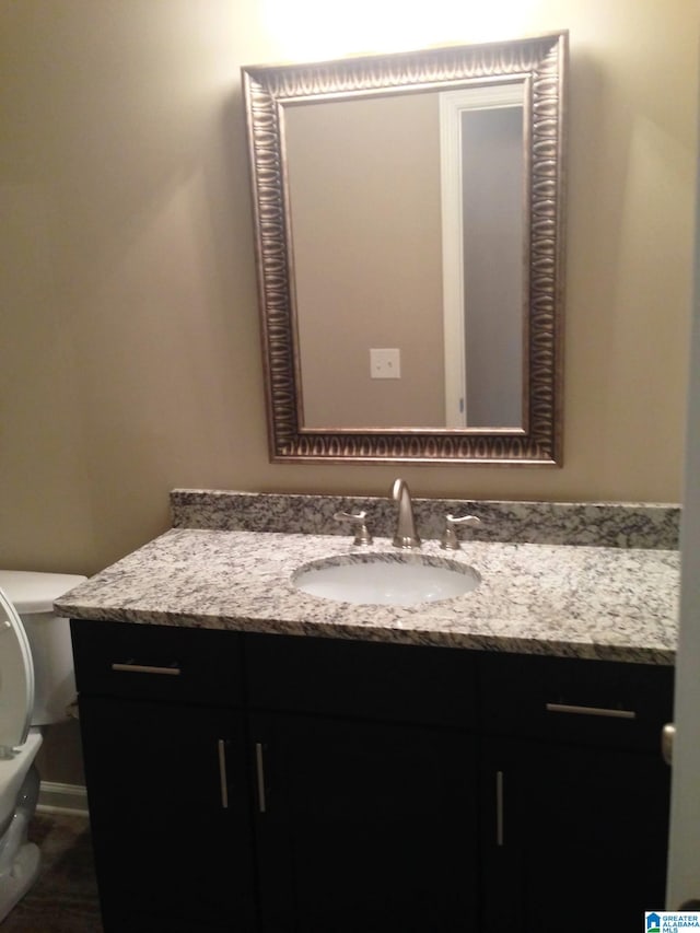 bathroom with toilet and vanity