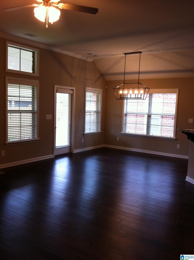 empty room featuring ceiling fan with notable chandelier, dark wood-type flooring, and ornamental molding