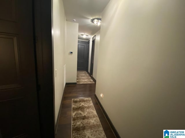 corridor with dark hardwood / wood-style flooring