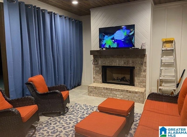 living area featuring a brick fireplace and wooden ceiling