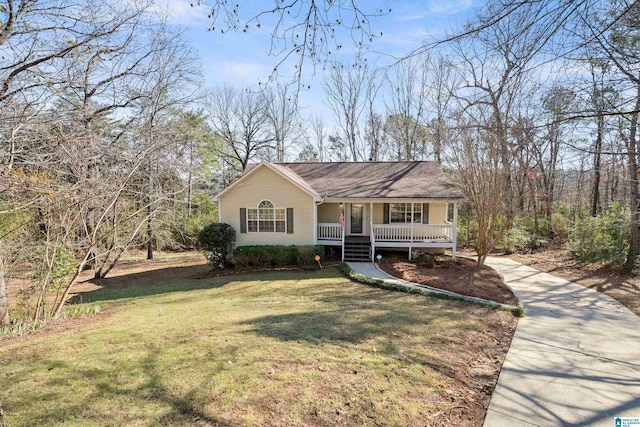 view of front of house with covered porch and a front lawn