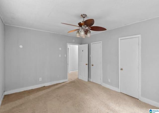 unfurnished bedroom featuring ceiling fan and light carpet