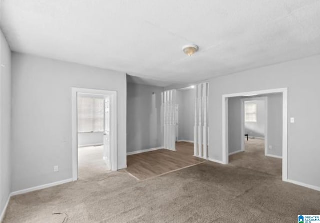 unfurnished room featuring carpet