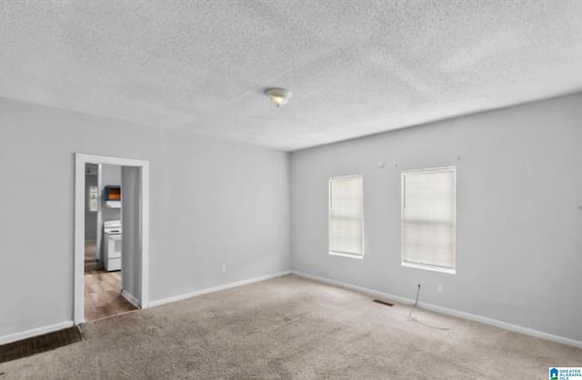 unfurnished room featuring dark carpet